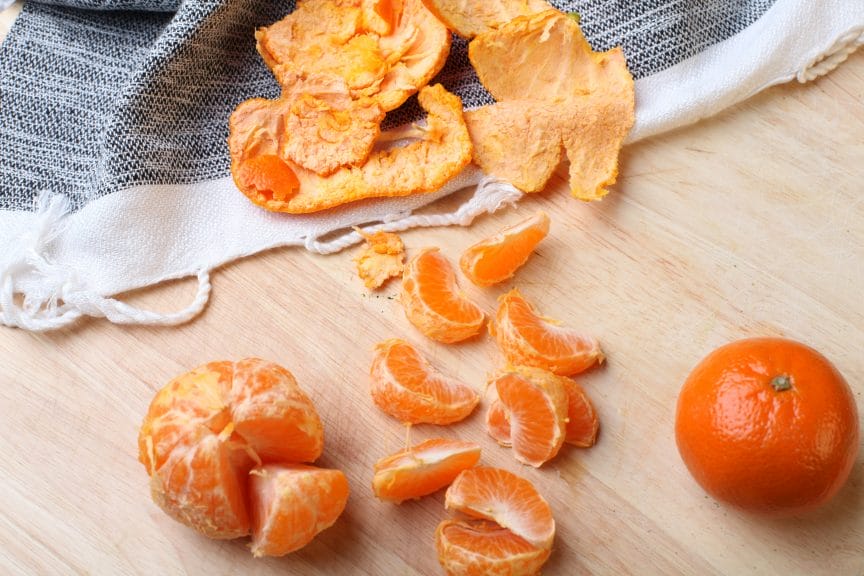 Oranges and peel on table