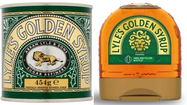 A gold and green tin reads 'Lyle's Golden Syrup' with an illustration of a dead lion surrounded by bees. Next to it is a semi-circle shape plastic bottle featuring the new logo of a happier lion face made of syrup