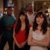 The cast of New Girl standing together and talking about a photo we cannot see.
