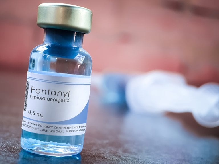 A fentanyl medical bottle pictured with pills.