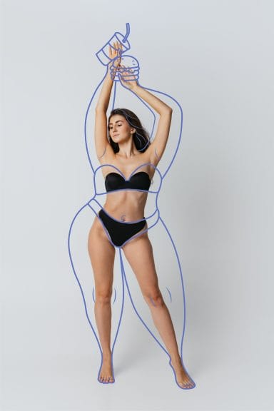 Fat-phobia - young beautiful slim woman in lingerie. Drawings of junk food and overweight lines around body.