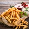 Image shows fries on a plate, with two dipping sauces.