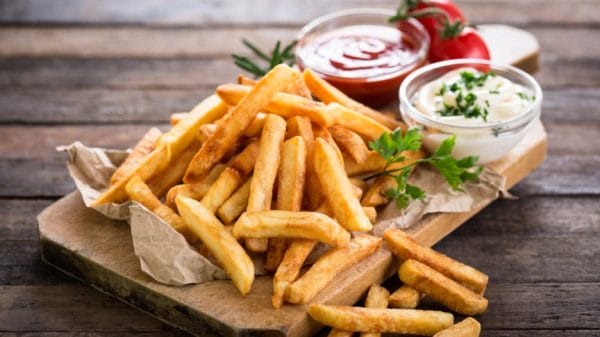Image shows fries on a plate, with two dipping sauces.