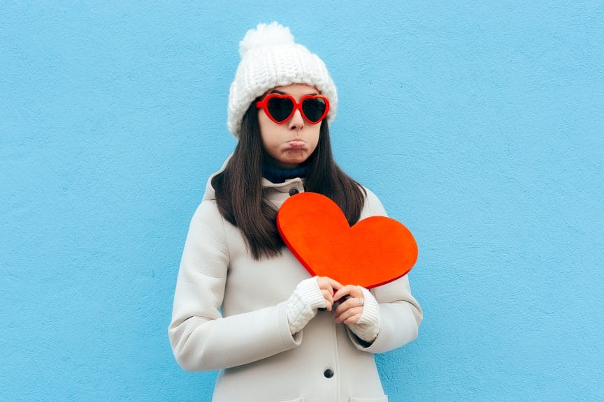 sad woman holding paper craft heart