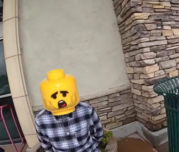 face of suspect is being covered with lego