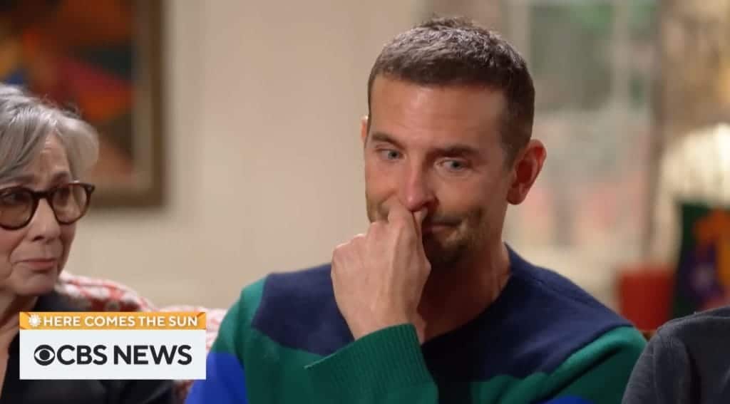 Actor Bradley Cooper looks teary-eyed as he responds to an interview question.