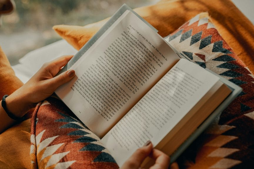 An open book being held by a woman