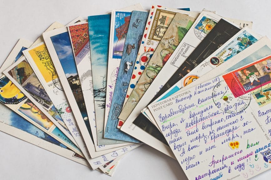 A spread of postcards from a variety of international trips.
