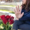 Woman rejecting a bouquet of roses, directly rejecting the catch after the chase