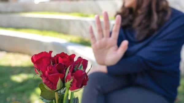 Woman rejecting a bouquet of roses, directly rejecting the catch after the chase