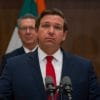 Image shows Ron DeSantis at a press conference.