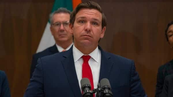 Image shows Ron DeSantis at a press conference.