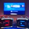 Two Video Game controllers, videogame joystick or gamepad on a table one red and one blue. Close up studio shot