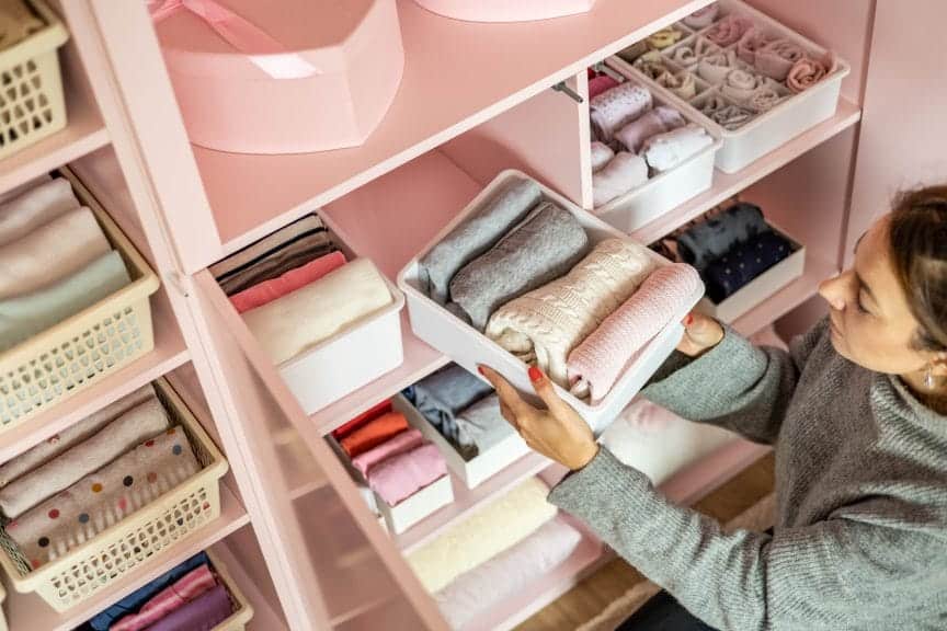 woman cleaning and organizing her closet