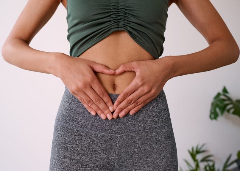 girl holding hands up to stomach