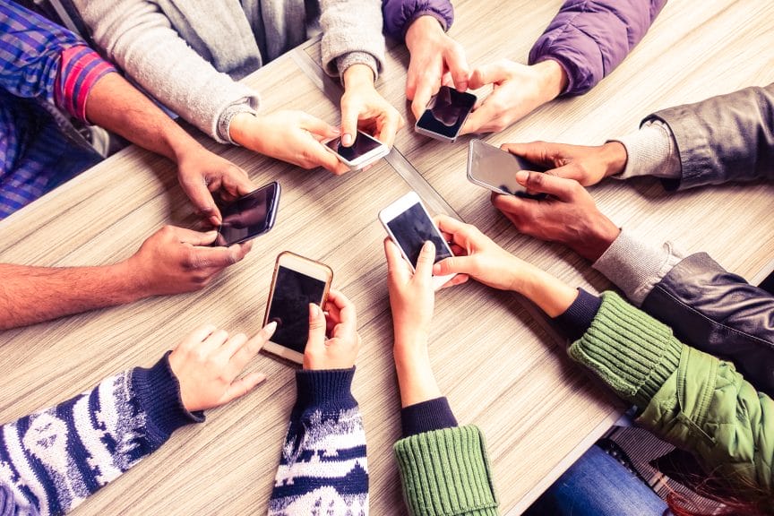 Overview look at group of people using their phones.