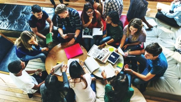 Group of college students sitting and studying.