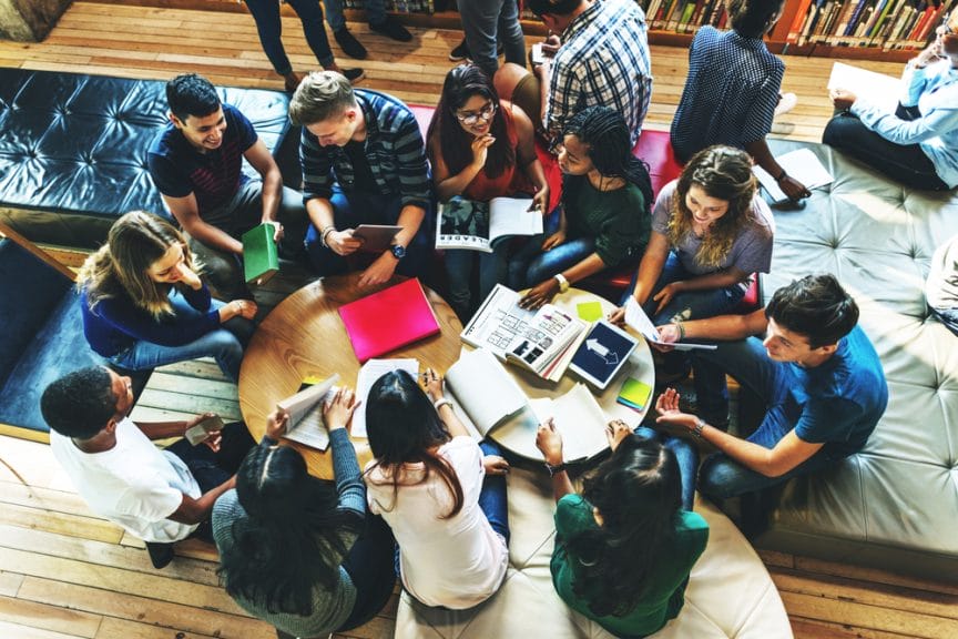 Group of college students sitting and studying.