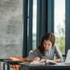 Young female student studying in library.