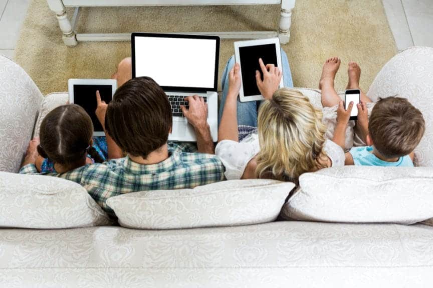 Overhead view of family using screens. Family screen time