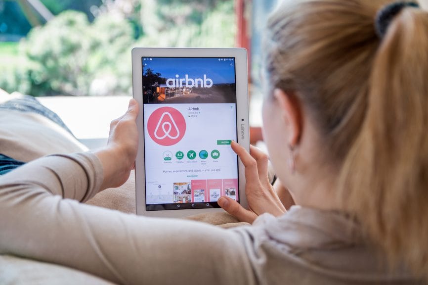 A lady downloading Airbnb app
