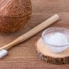 coconut and oil on table with toothbrush