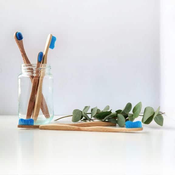 toothbrushes on a counter in a jar