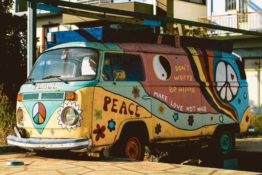 '70s subculture hippie van with various words for peace and love painted on.