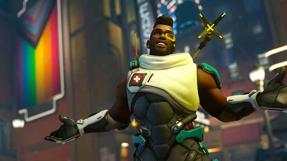 Baptiste from Overwatch in front of a pride flag.