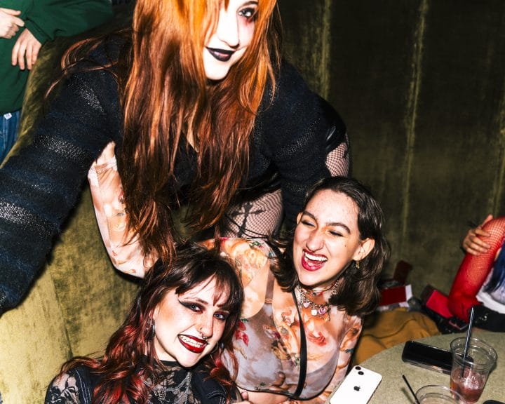 Punk show attendees wear cross patterned clothes and goth color palettes