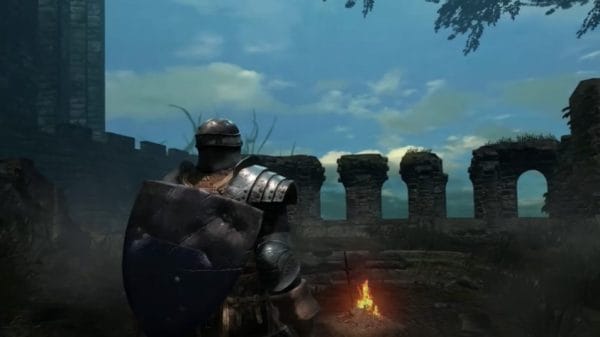 A player character arrives at a small grove surrounded by stone ruins with a fire in the center. YouTube/FightinCowboy