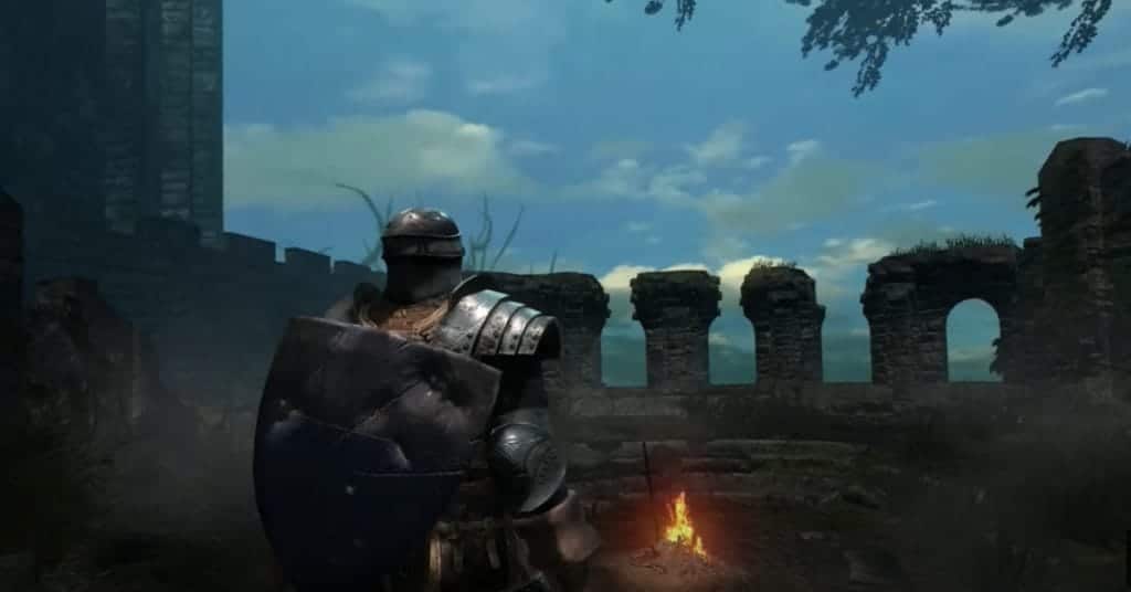 A player character arrives at a small grove surrounded by stone ruins with a fire in the center. YouTube/FightinCowboy