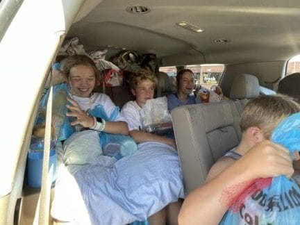 Car full of suitcases, kids, and groceries.
