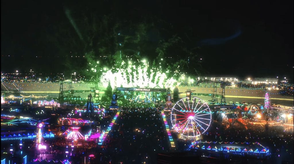 Overhead view of Electric Daisy Carnival with fireworks and fairground rides