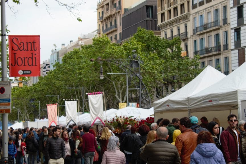 People walking along Passeig de Gràcia on Saint George's Day.