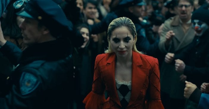 Image shows Harley Quinn, played by Lady Gaga, walking up steps.