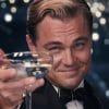 Jay Gatsby (Leonardo DiCaprio) looks into the camera with a glass.