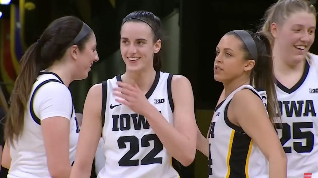 Caitlin Clark, Iowa basketball player, celebrating with teammates after a game