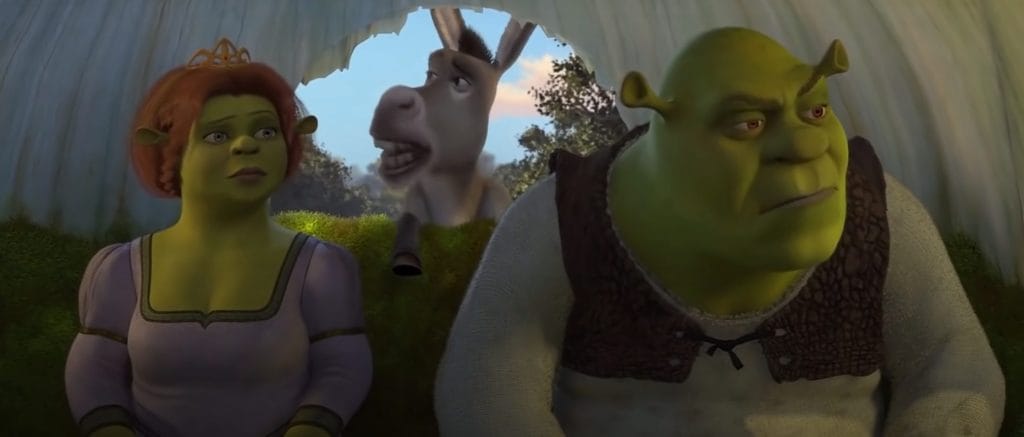 Fiona, Donkey, and Shrek sit in their carriage.
