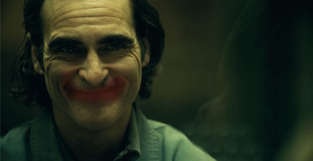 Joaquin Phoenix, as the Joker, smiles creepily in the trailer for "Joker: Folie A Deux."