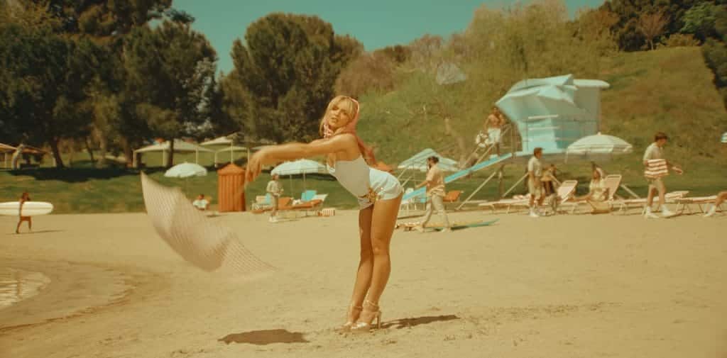 Sabrina Carpenter - Espresso Music Video - Custom Carol Ai Studio sky blue bathing suit adorned at the hip with an embroidered gold sequin starfish.