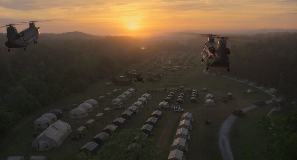 Helicopters fly above a Western Forces camp in Civil War.