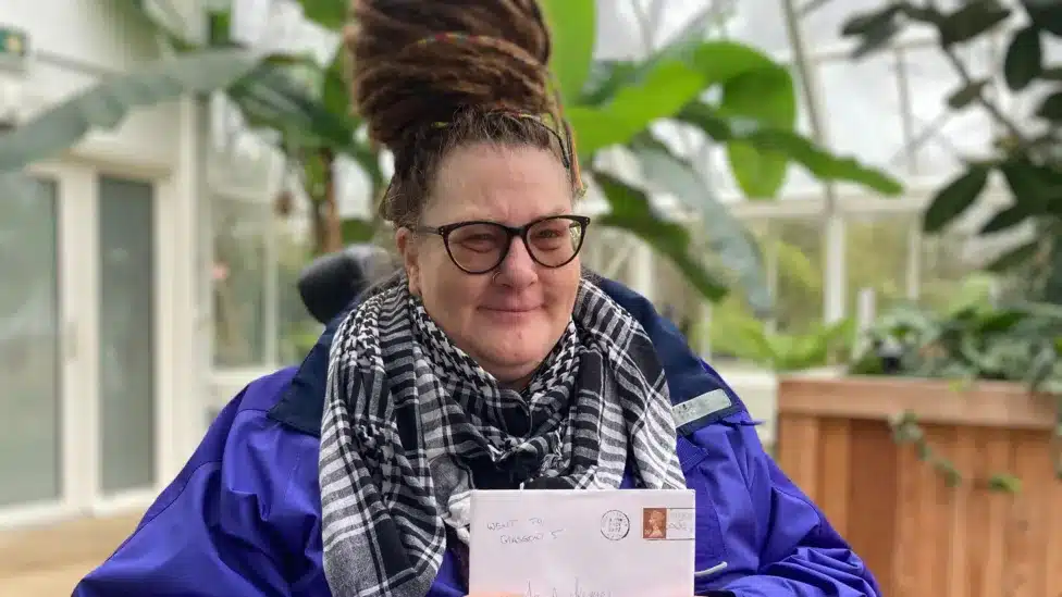 Ms. Meleyal holding the letter she received with a smile.
