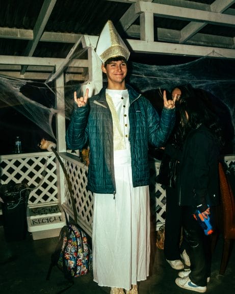 A punk show attendee is dressed in a priest costume