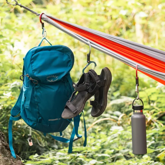 Blue Bag, brown shoes, and water bottle handing on hammock by HeroClip