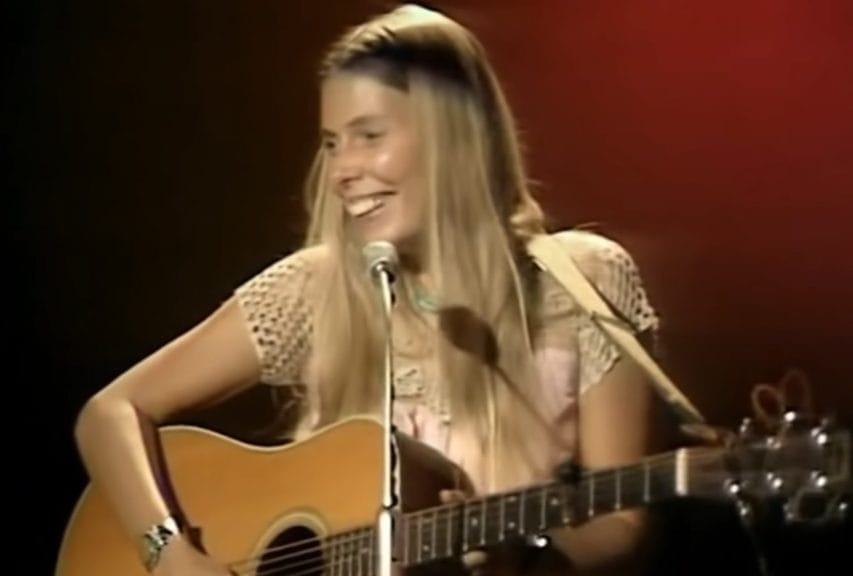 Joni Mitchell performing with her guitar in 1969. 