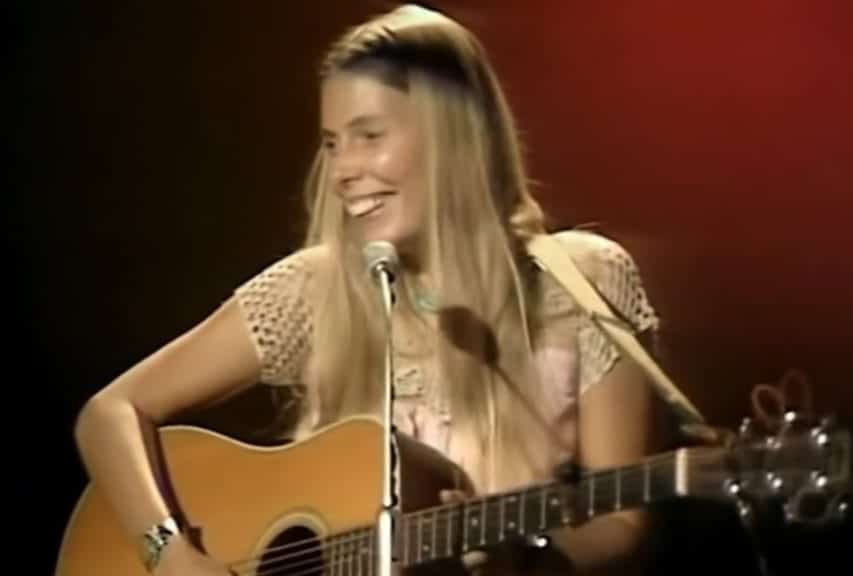 Joni Mitchell performing with her guitar in 1969.