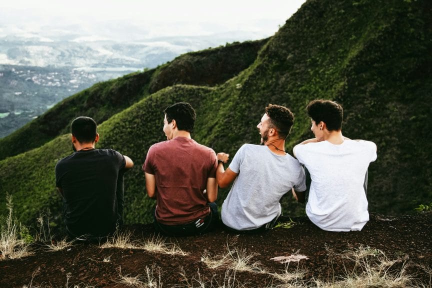 friends laughing overlooking mountains