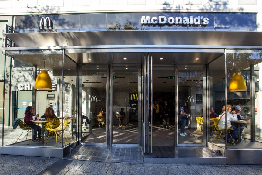 A building made of glass with 'McDonald's' in white at the top