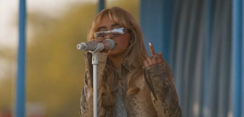 Sabrina Carpenter flashes a middle finger to the camera as she performs for the first time at Coachella.